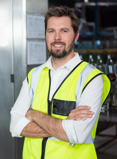 Male factory supervisor in hi-vis vest