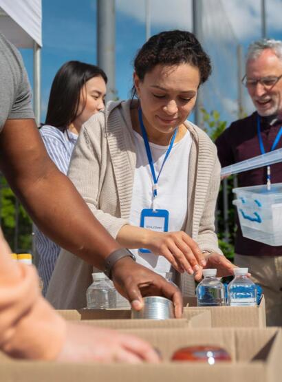 Volunteers looking at boxes of food and drink